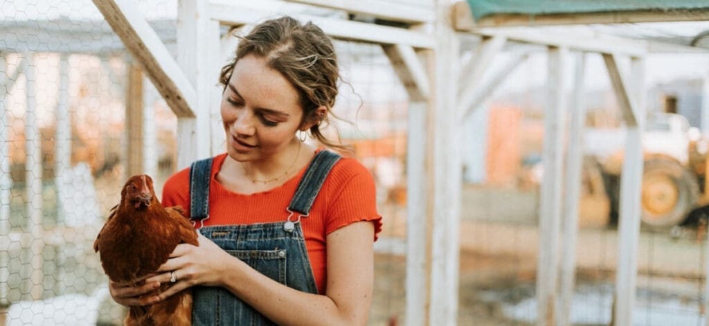 Woman with chicken and hens